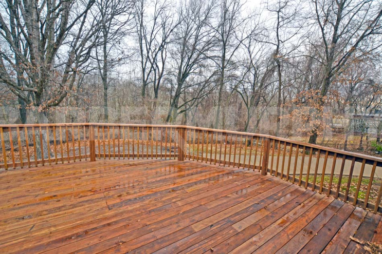 Large Deck overlooking .55 Acre property and rear parking 