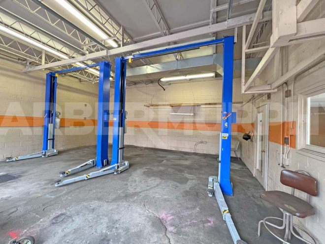 Shop interior with 2 car lifts included in the sale 